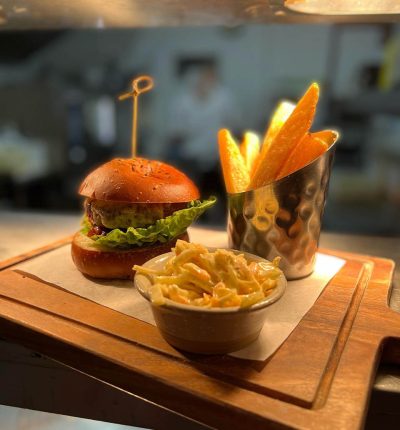 Clive’s Handmade burger, pickled cucumber, melted cheese & homemade tomato relish triple cooked chips & Slaw